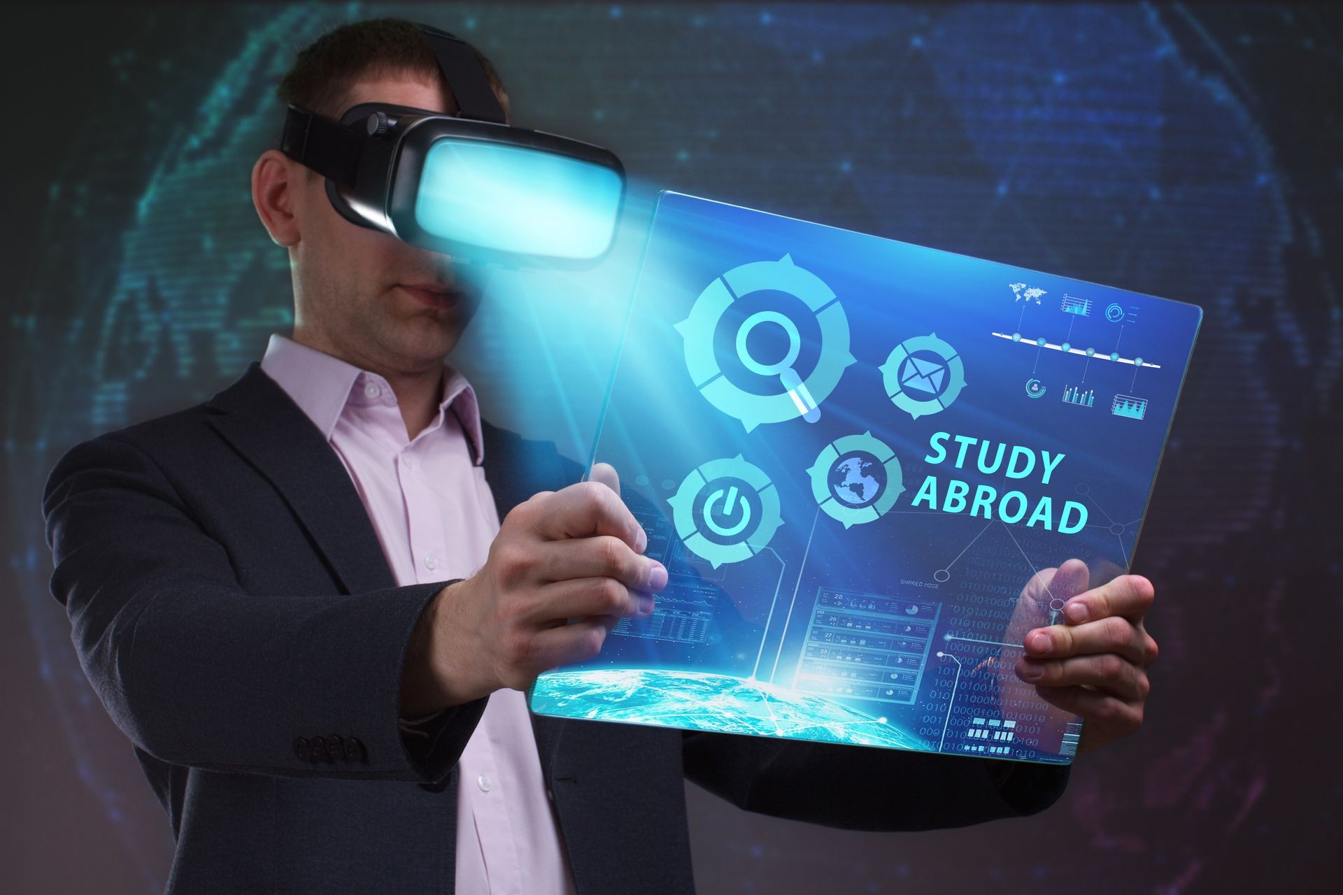 Business, Technology, Internet and network concept. Young businessman working in virtual reality glasses sees the inscription: Study abroad